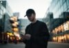 Are the Online Matka Platforms Responsible for Covering Your Financial Loss if Your Account Is Hacked? man in black jacket wearing black fitted cap while using phone