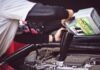 Engine Troubles: Does Car Insurance Cover Engine Failures? man refilling motor oil on car engine bay