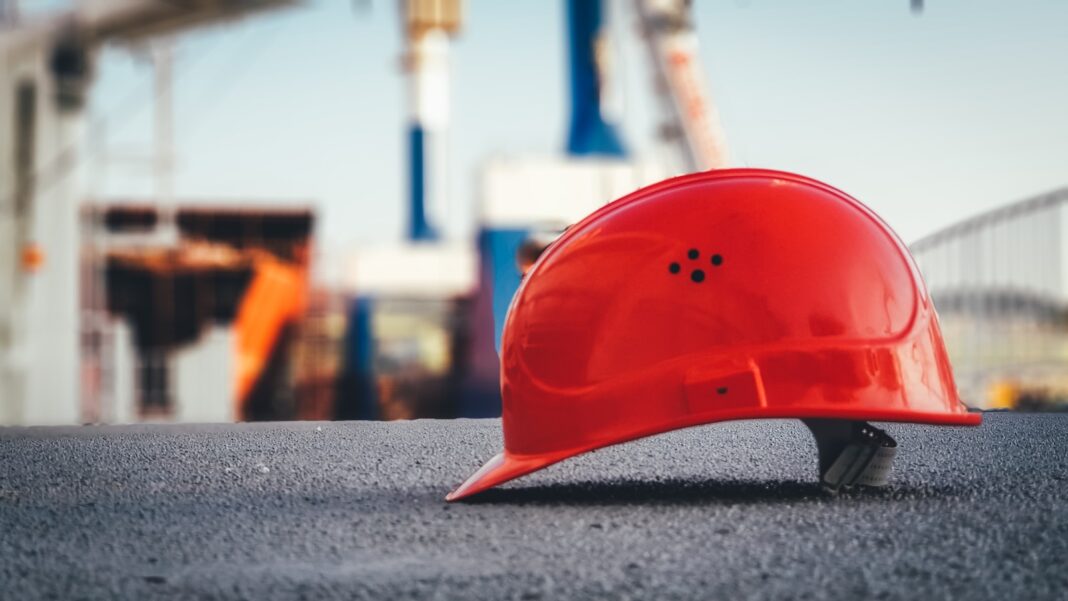 Photo by Ümit Yıldırım red hard hat on pavement