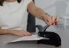 How Online Notary Services Are Transforming Legal Transactions woman in white shirt holding pen writing on white paper
