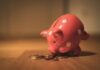 How to Become Independently Wealthy: 11 Strategies for Success pink pig coin bank on brown wooden table