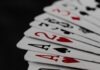 Poker Game Development: Designing an Immersive Gaming Universe a stack of playing cards sitting on top of each other