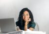 Discover the WEWATCH Hub: Your Exclusive Community for Enthusiasts Happy ethnic woman sitting at table with laptop