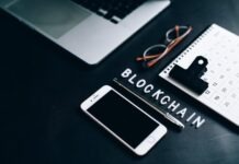 Blockchain Revolutionizing Sectors: What Lies Ahead in the Future Smartphone, Pen, Calendar and Eyeglasses on Flat Surface