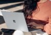 Mastering the Online Lottery in India: Top Tips and Tricks for Success woman in orange long sleeve shirt and white pants sitting on floor using Surface Laptop