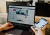 Boost Your Online Reputation with Social Media: Strategies for Success person using both laptop and smartphone