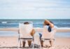 Family Fun Unleashed: A Guide to Crafting Memorable Vacation Experiences woman in black and white stripe dress sitting on white chair on beach during daytime