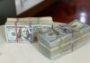 The Art of Simplifying Loan Processes: A Look at Personal Loan Online Apps a stack of money sitting on top of a white table