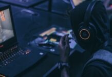 Evolution Gaming Reports 20% Revenue Growth In 2022, Company’s Perspectives man playing on gaming lapto p