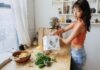 Revitalize Your Health Journey: A Comprehensive Guide for a Healthier You a woman standing in front of a wooden table