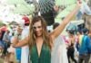 Setting the Trend: Emerging Styles of Country Festival Clothing woman raising her hand