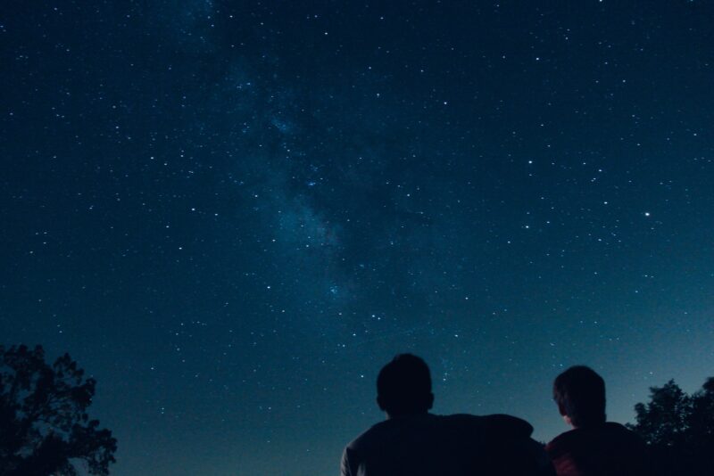 Photo by Ryan Jacobson silhouette photo of two person watching stars