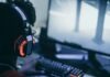 Social Gaming Is at an All Time High — This Is Why person wearing orange and black headphones