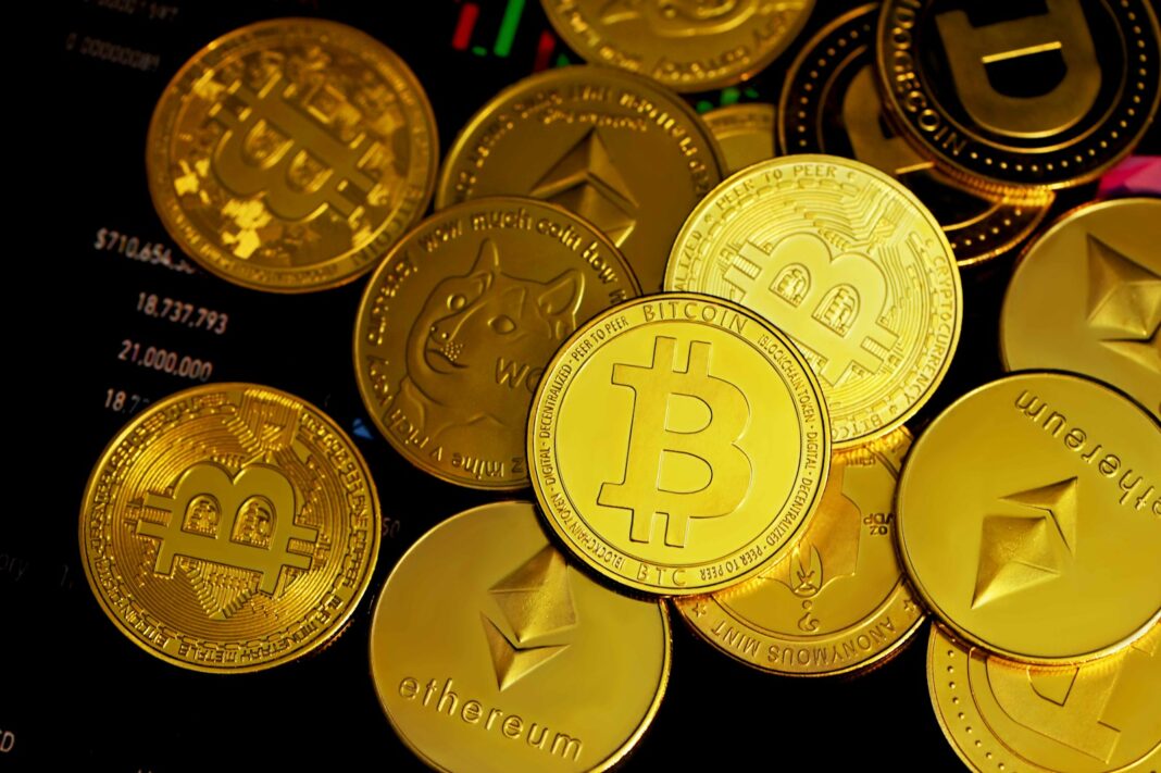Photo by Kanchanara a pile of gold bitcoins sitting on top of each other