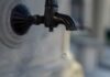 How to Read a Water Meter UK black metal faucet in close up photography