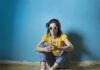 Unveiling the World of Digital Entertainment: A Guide to Online Gaming Platforms Photo of Woman in Yellow T-shirt, Blue Jeans, and White Sunglasses Sitting on Wooden Floor In Front of Blue Wall