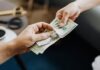 All About the Hidden Costs of Personal Loans in India Hands Holding Us Dollar Bills