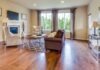 The Importance of a Durable Wear Layer in Hardwood Flooring a living room filled with furniture and a fire place