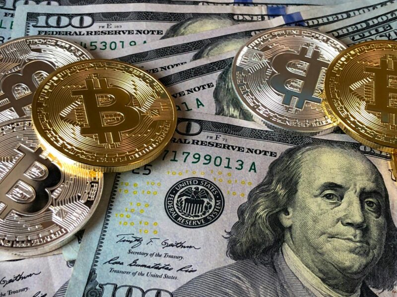 Photo by David McBee Bitcoins and U.s Dollar Bills