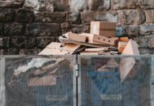 How to Scale Down Cardboard and Plastic Waste to Gain a Competitive Advantage brown cardboard boxes on black steel frame