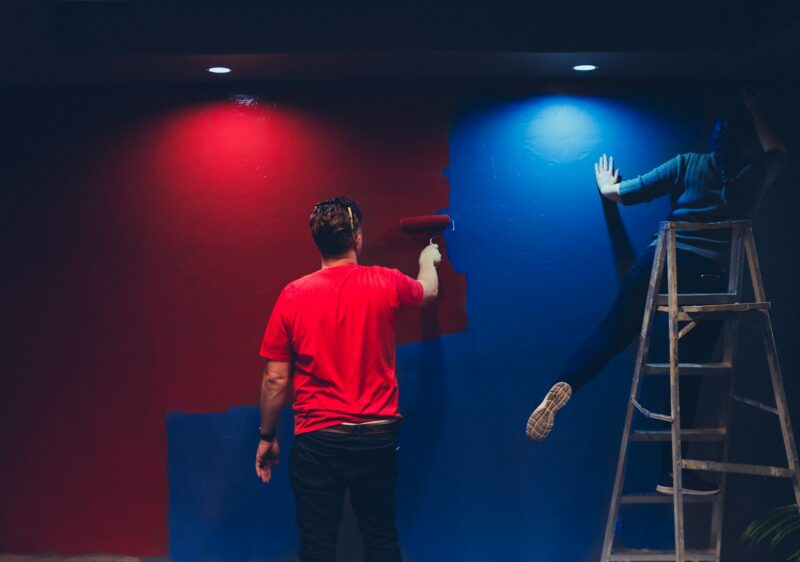 Photo by Kenny Eliason man and woman painting wall