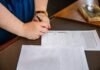The Procurement Maze: How Higher Education Navigates the Challenges person holding pen and writing on paper
