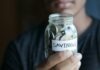 Planning for the Future: How Retirement Planning Can Secure Your Finances a man holding a jar with a savings label on it