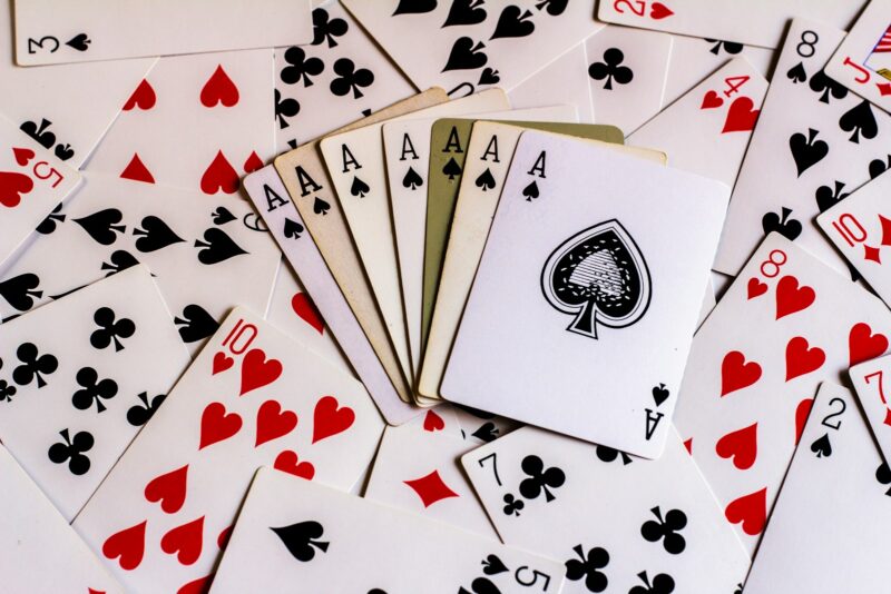 Photo by aceofnet a pile of playing cards sitting on top of each other