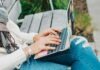 Asiavibe: Communication Platform for a Pleasant Chatting Experience person in white long sleeve shirt and blue denim jeans using macbook pro