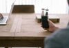 918kiss’s Guide to Achieving Gaming Excellence person holding smartphone in front of brown table