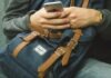 The Best Apps for Having Fun on Your Phone man holding his phone while sitting on chair