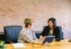 How HR and Payroll Software in the UAE is Transforming the Way Businesses Operate! two women sitting on leather chairs in front of table