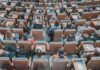 Challenges and Innovations in University Learning high-angle photography of group of people sitting at chairs