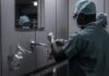 The Unsung Hero of Healthcare: Polymers in Medical Devices and Implants man wearing surgical suit near mirror