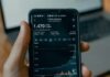 Fixed-Rate Bonds: An Overview of How They Function a person holding a cell phone in front of a laptop