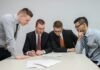 Which Skills Should You Prioritize When Training Your Employees? four men looking to the paper on table