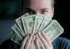 The Key to Business Loans: How Inventory Financing Supports Large Business Operations person holding fan of U.S. dollars banknote