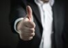 How Turnkey Solutions Simplify Starting New Businesses A close-up of a man's thumbs up gesture, symbolizing success and agreement.