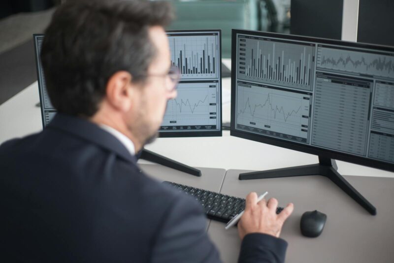 Photo by Kampus Production Man in Black Suit Jacket Using Computer