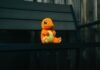 Top 3 Pokemon Go Location Spoofer for Android 15 and iOS 18 a stuffed toy sitting on top of a wooden bench