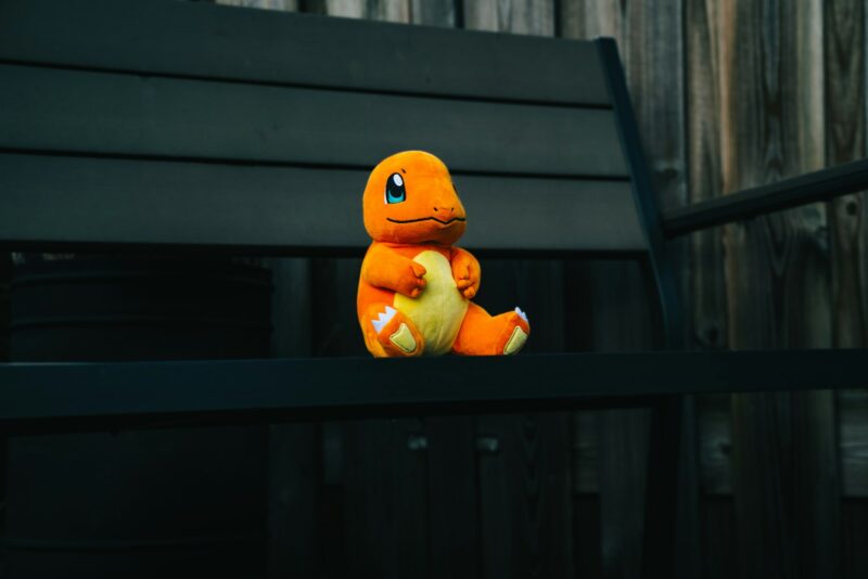 Photo by Akin Cakiner a stuffed toy sitting on top of a wooden bench