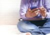 Advantages of the Mostbet Mobile Version man in white dress shirt and blue denim jeans sitting on bed
