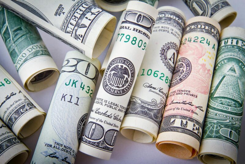 Photo by Pixabay Close-up of rolled US dollar bills symbolizing wealth, financial success, and currency.