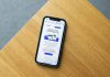 Email Marketing Automation Tools and Best Practices Mobile phone with an e-commerce interface on a wooden surface, illustrating online shopping technology.