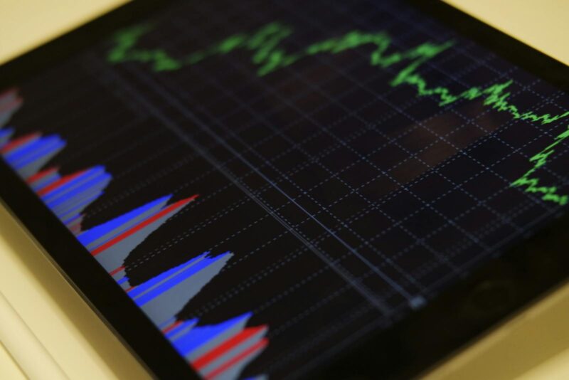 Photo by Burak The Weekender Close-up of a tablet displaying stock market analysis with colorful graphs.