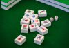 Mahjong Slot: A Fusion of Culture and Gaming Excitement a group of dices sitting on top of a green table