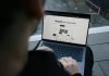 What Is a Business Loan and How Can It Propel Your Business Growth? A man sitting on a bench using a laptop computer