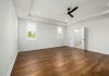 A-Level Tenant Screening Tips and Techniques for Property Owners Empty modern bedroom with hardwood floors and ceiling fan, perfect for customization.