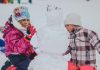 Fun Things to Do with Kids When it Snows two girl molding a snowman during daytime