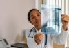 5 Symptoms of Mesothelioma to Know About Healthcare professional analyzing chest X-ray in modern medical office.